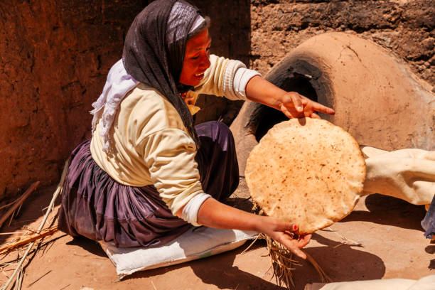 Moroccan woman making bread (khubz) in traditional way.