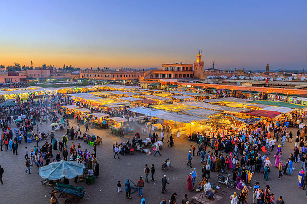 Famous Djemaa El Fna Square in early evening light, Marrakech, Morocco with the Koutoubia Mosque, Northern Africa.Nikon D3x